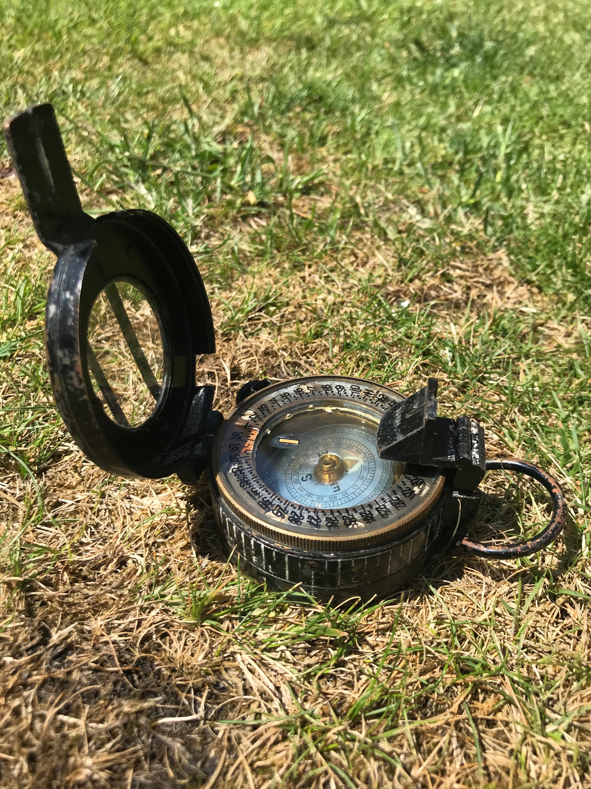 1944 dated WW2 vintage British compass on grass