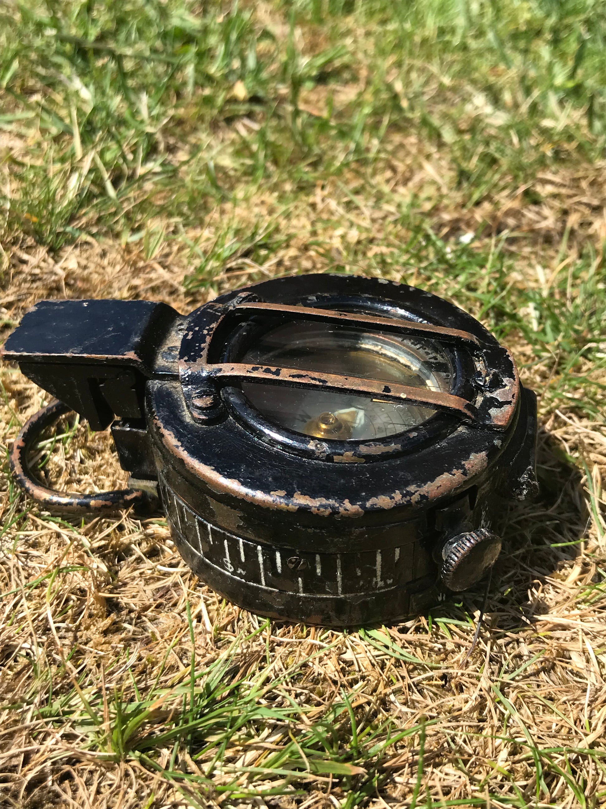 Closed 1944 dated WW2 vintage British compass on grass