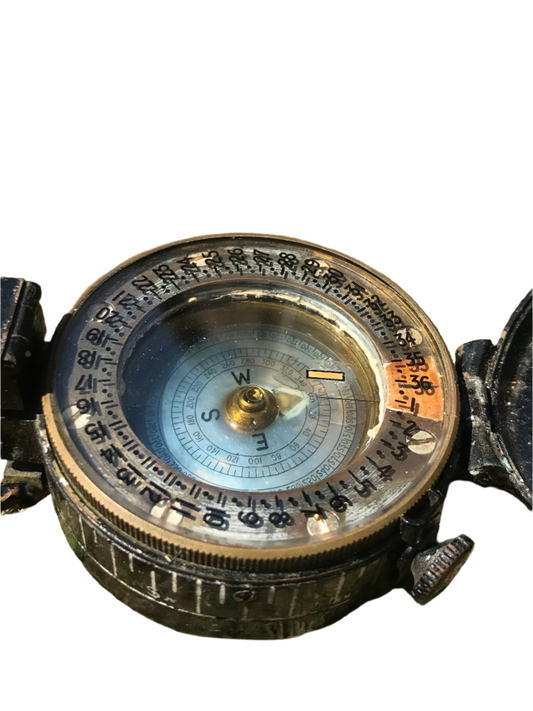 1944 dated WW2 vintage British compass on a white background