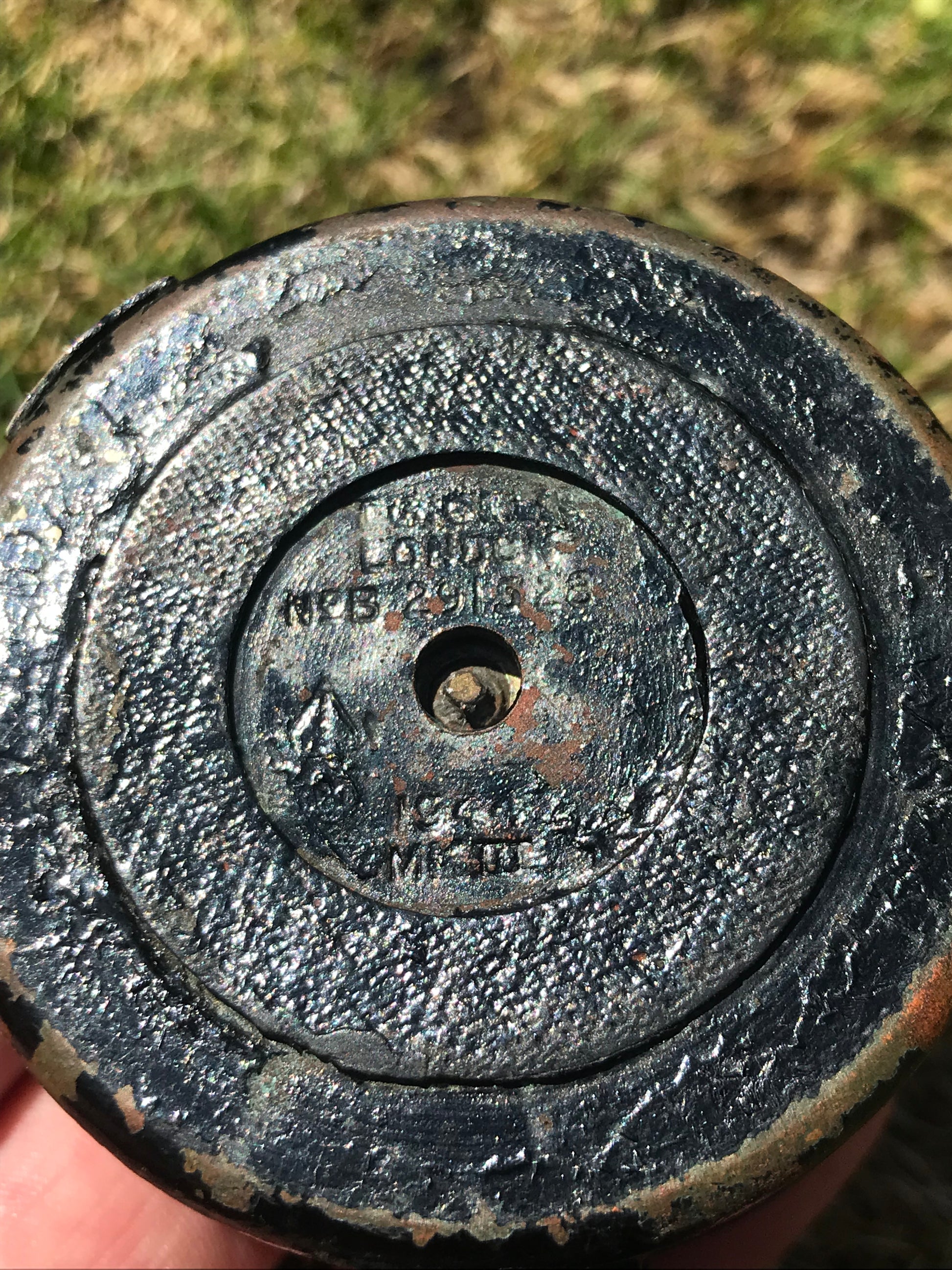 1944 dated WW2 vintage British compass  with inscriptions and grass in the background